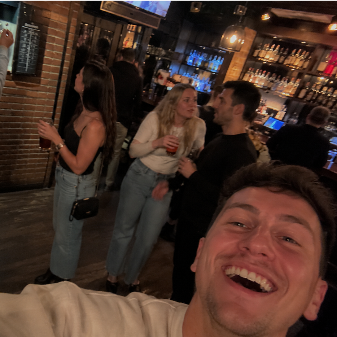 A group playing darts together on a pub crawl stop