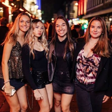 A group of friends smiling together on ladies night